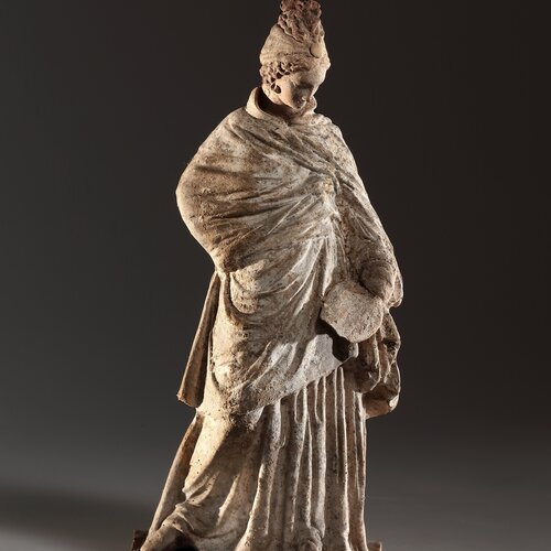 A Robed Female Statuette with Fan (Tanagra Figurine)